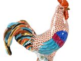 a figurine of a rooster on a white background