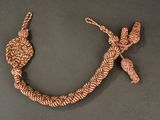 a close up of a necklace with a knot on it