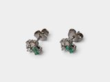 a pair of emerald and diamond earrings on a white background