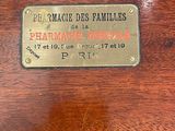 a brass plaque on the back of a wooden table