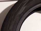 a close up of a tire on the side of a white wall