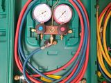 two green cases with gauges and hoses in them