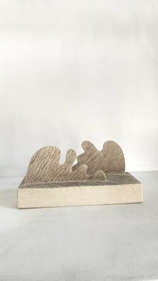 figurine en bois représentant un homme et une femme allongés sur un lit