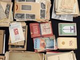 a lot of old books on a table with a pen