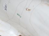 underside view of a white porcelain vase with a floral design