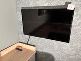 a flat screen tv mounted on a wall in a room