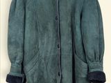 an image of a jacket hanging on a hanger on a wall
