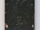 a black piece of luggage sitting on a white surface