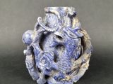 a blue vase with a dragon on it sitting on a table