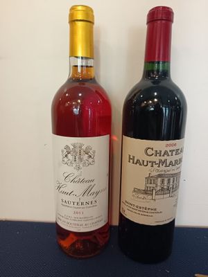 two bottles of wine sitting next to each other on a table