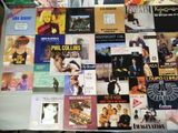 a bed covered with many different album covers on it