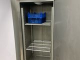 a refrigerator that is open and has a basket in it