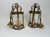 pair of antique brass lanterns with clear glass and gold accents