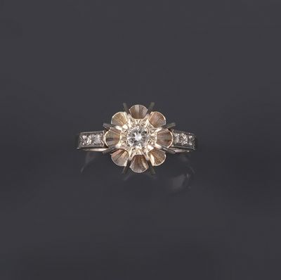 a close up of a diamond ring on a black surface