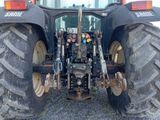 a tractor that is sitting in the gravel