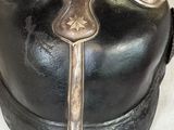 a black helmet with a cross on it on a table