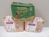 three packages of diapers sitting on a table