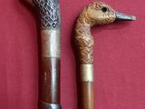 two canes that are sitting next to each other on a red surface