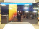 a man taking a selfie in front of a television screen