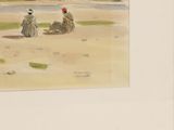 two people sitting on the beach with a kite in the sky