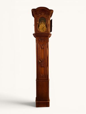 a wooden grandfather clock that is standing on a white surface