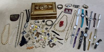 many different types of watches and bracelets laid out on the floor