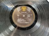 an old record with a label on it sitting on top of a table