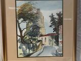 tableau encadré représentant une rue avec des arbres et des bâtiments