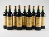 six bottles of wine are lined up in a row
