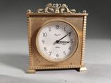 a small clock that is sitting on a table