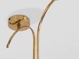 a pair of brass plated floor lamps on a white background