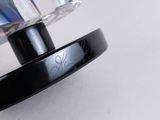 a close up of a black and silver object on a white surface