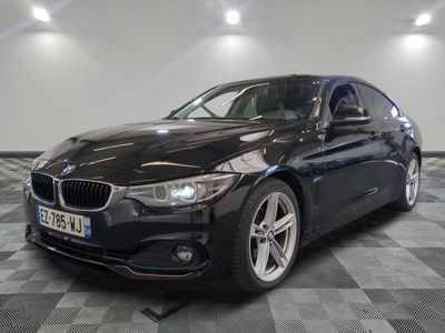 a picture of a black bmw car in a showroom