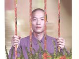 a picture of a man behind bars with flowers in front of him