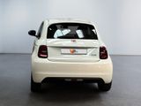 a small white car that is parked in a room