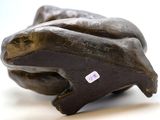 a sculpture of a frog that is sitting on a table