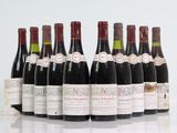 six bottles of wine are lined up in a row on a table