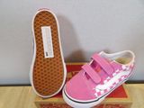 pink and white checkerboard vans slip - on shoes on a box