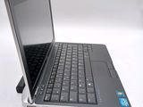 a laptop computer sitting on top of a white table
