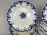several blue and white plates are stacked on top of each other