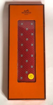 an orange box with a red tie in it on a white surface