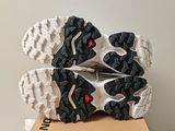 the soles of a pair of running shoes on top of a cardboard box