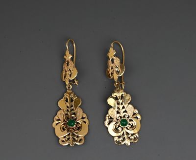 a pair of gold and emerald earrings
