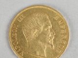 a close up of a gold coin on a white surface