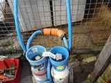 a cart with two cylinders and a hose in it