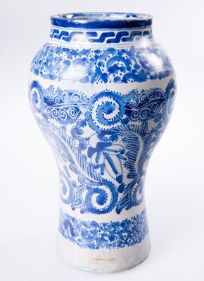 a blue and white vase sitting on a white surface