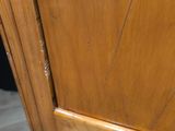 a close up of a wooden door with a black handle