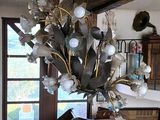 a chandelier that has a bunch of flowers in it