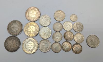 several different types of coins are arranged on a white surface