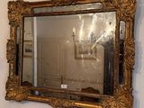 a mirror hanging on a wall in a room